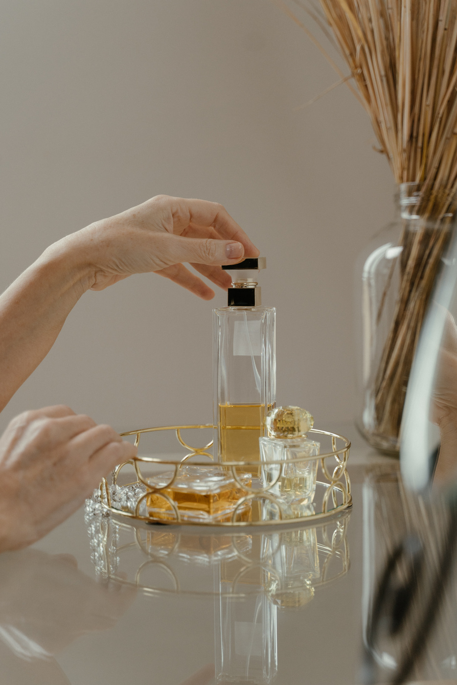 Person Holding a Bottle of Perfume